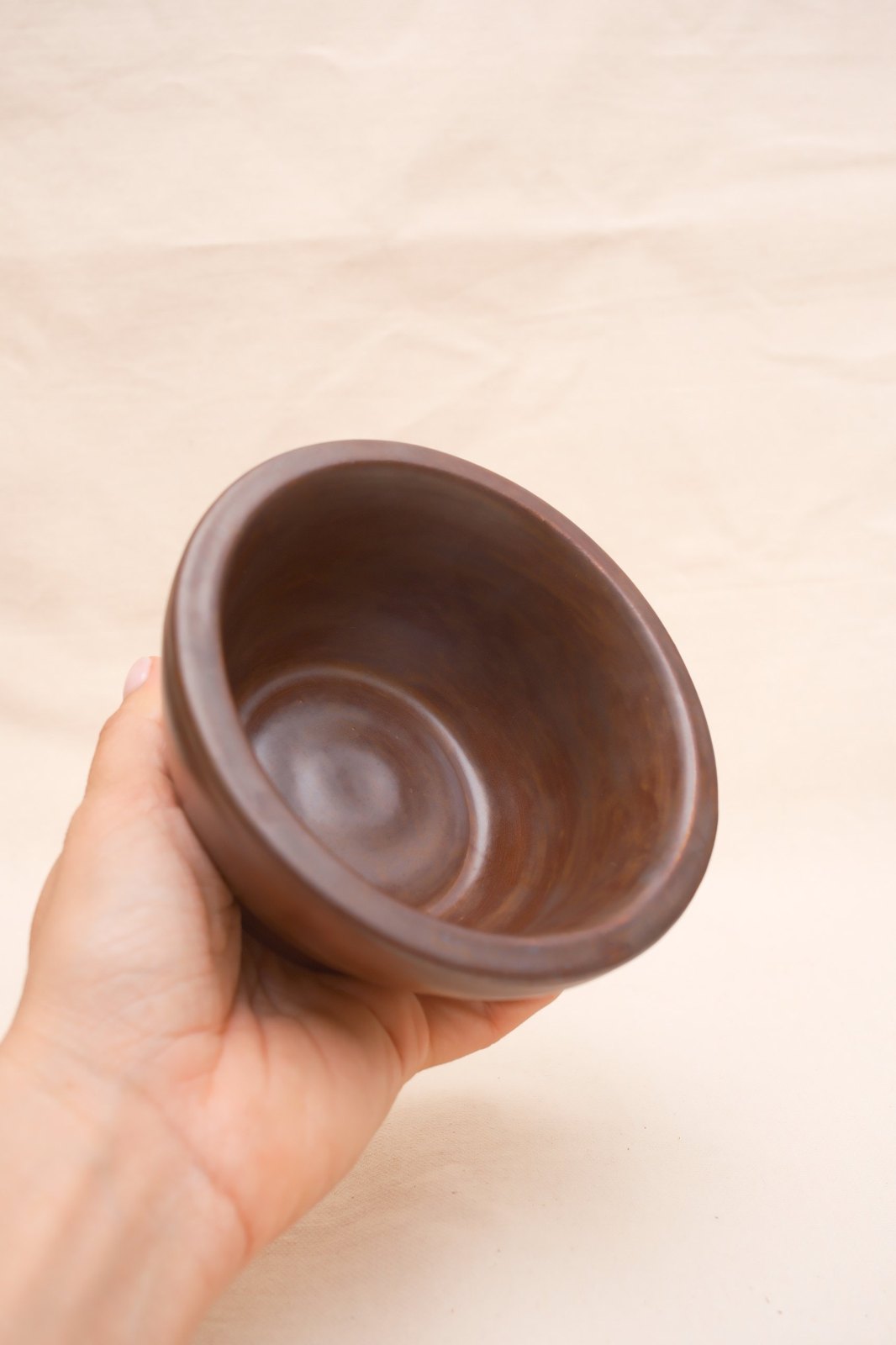 Looking into the bowl in hand at the throwing rings inside