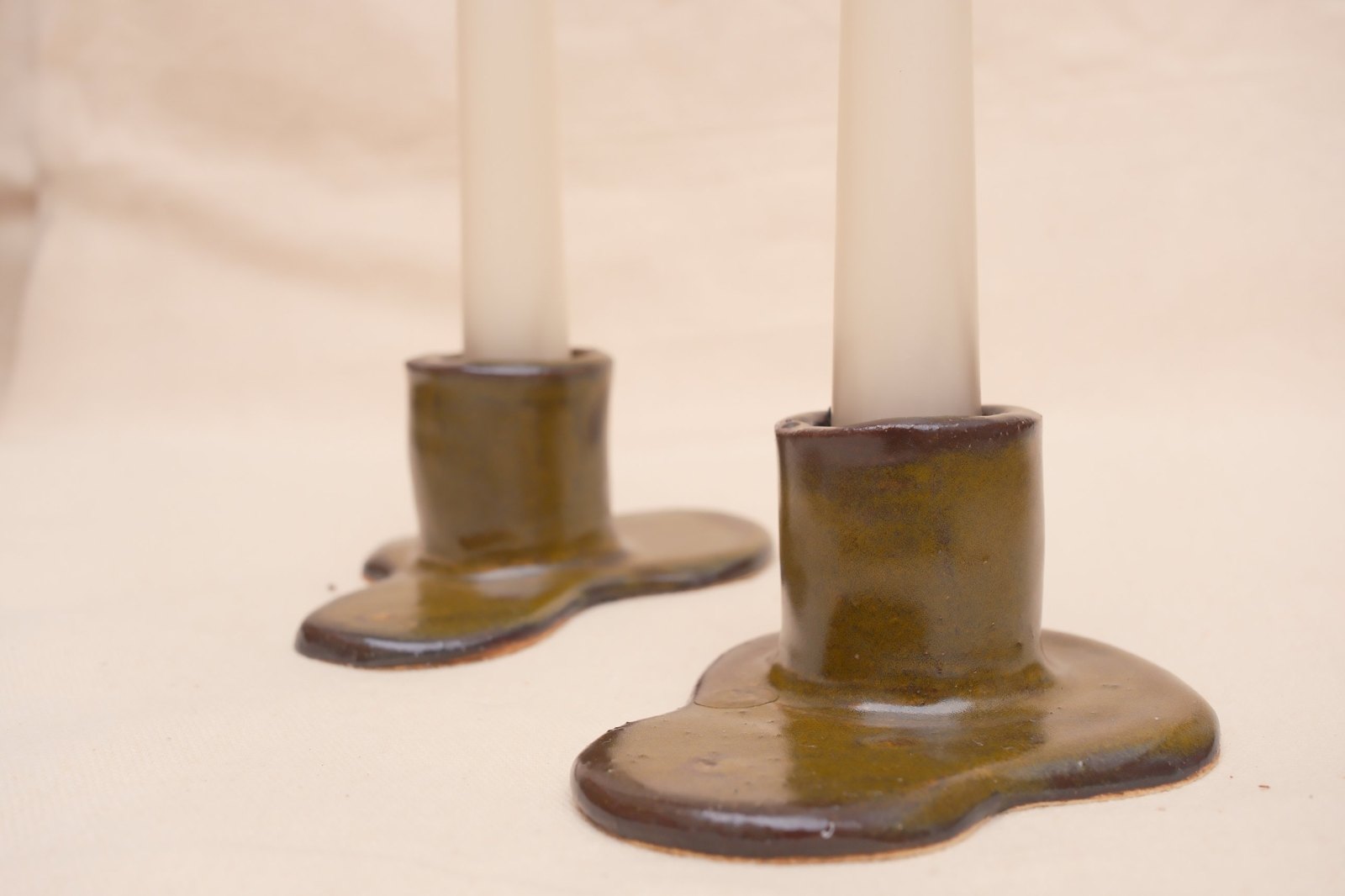 One holder in focus in front of the other, showing the soft, pooled base