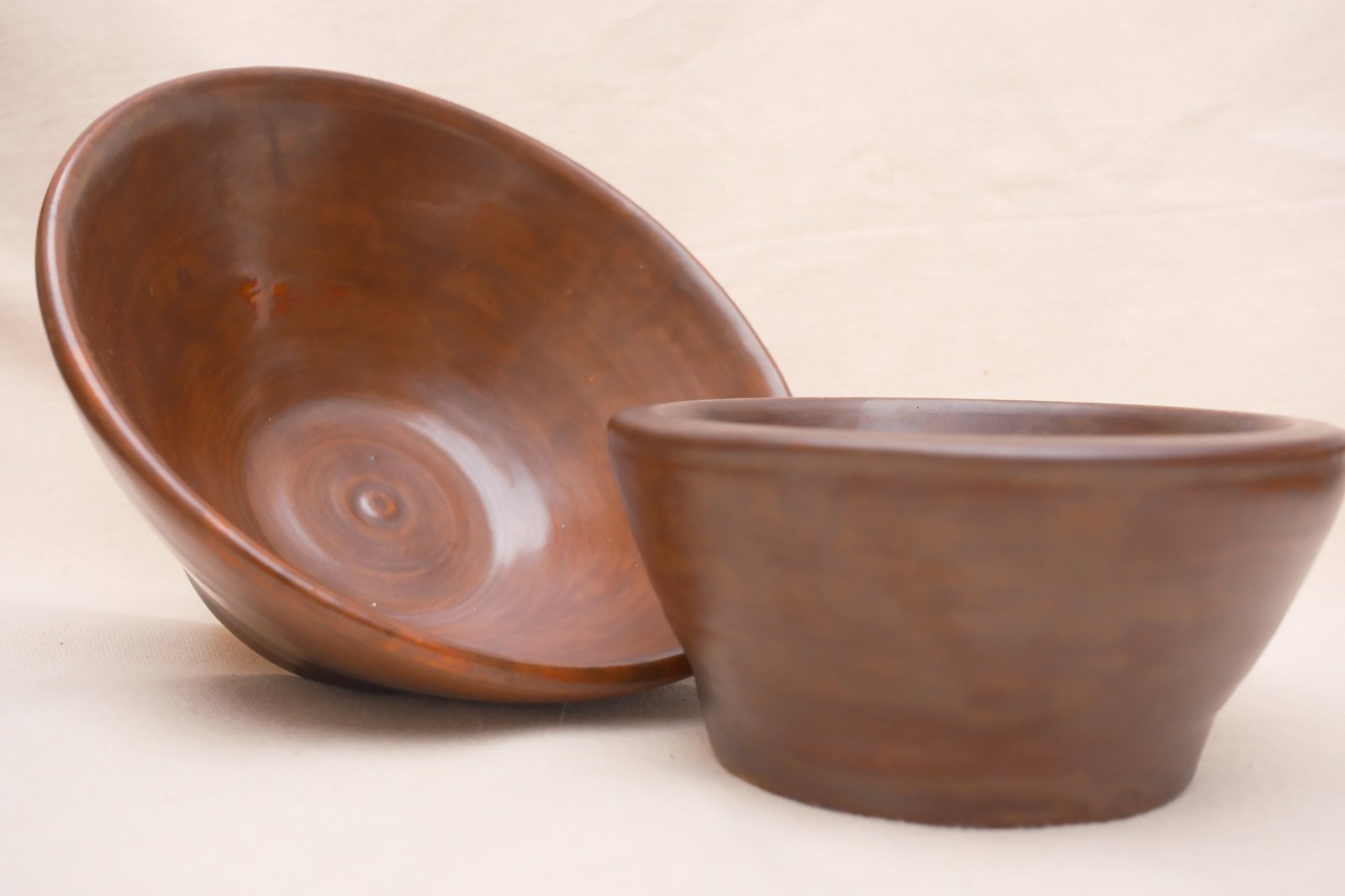 Close view of the pair, throwing rings swirling inside the flared bowl