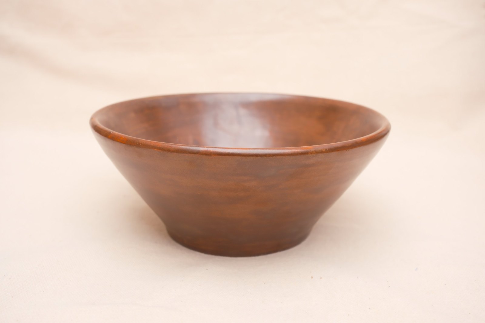 Wide flared bowl in Black Walnut glaze, on linen