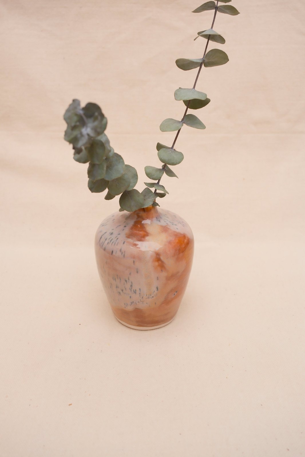 The vase from above with two eucalyptus stems