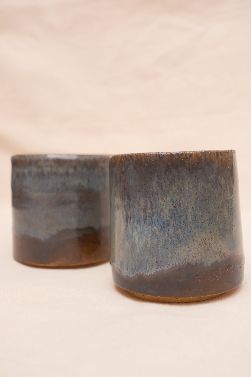 The pair close up, one in soft focus behind