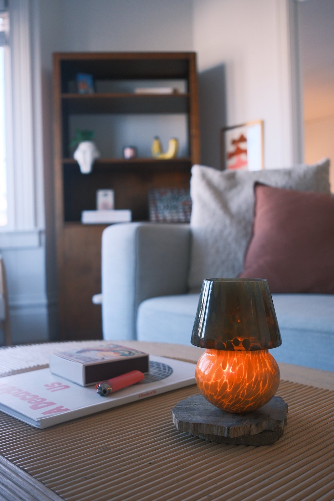 Glowing tortoiseshell glass mushroom lamp on a fluted coffee table