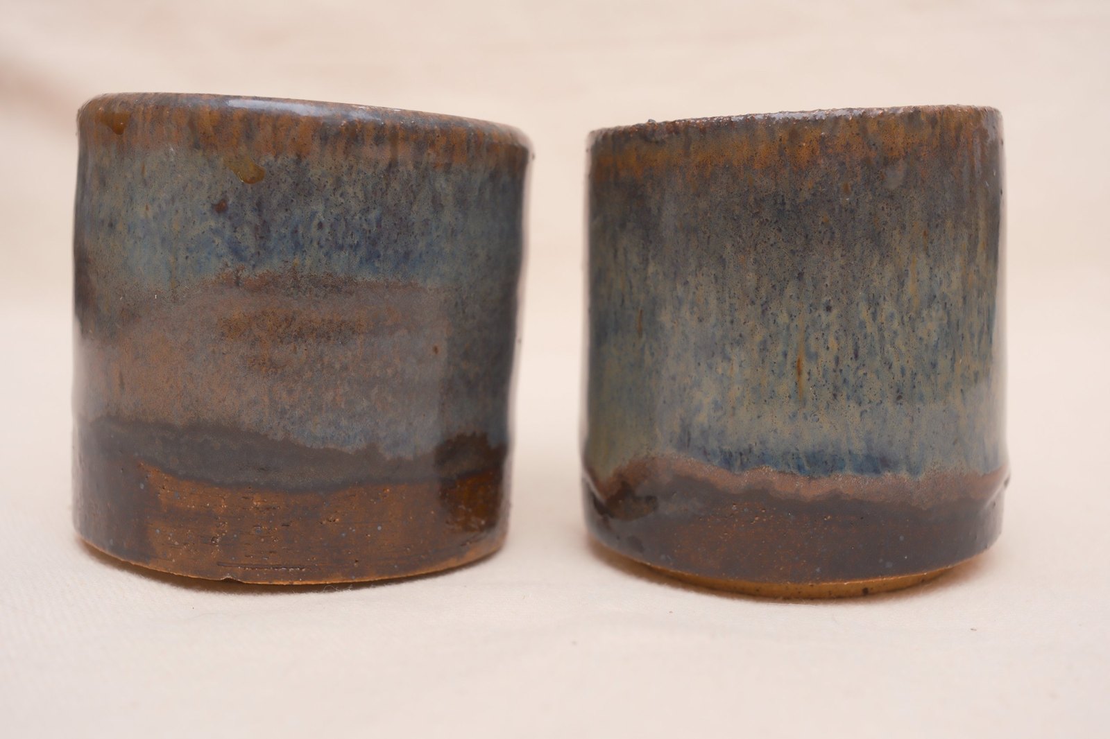The pair straight on, the glaze line differing on each