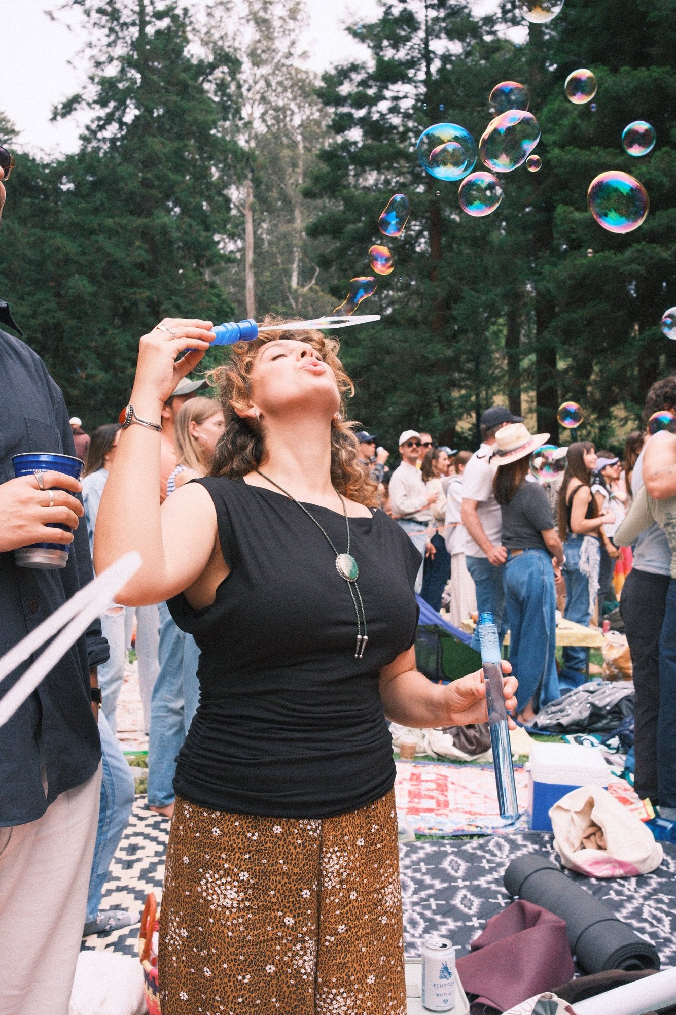 Eyes closed, blowing a stream of bubbles at Stern Grove