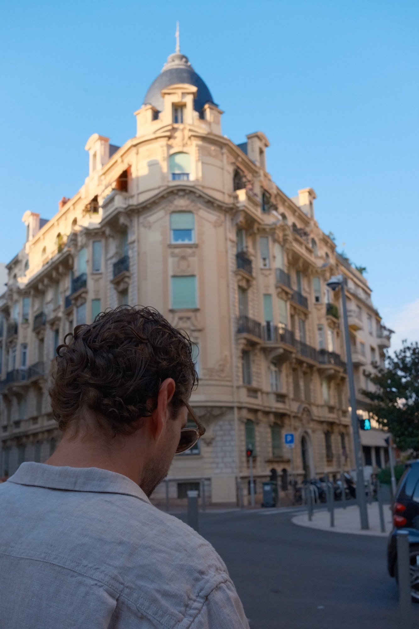 Curls in the foreground, the domed corner building behind