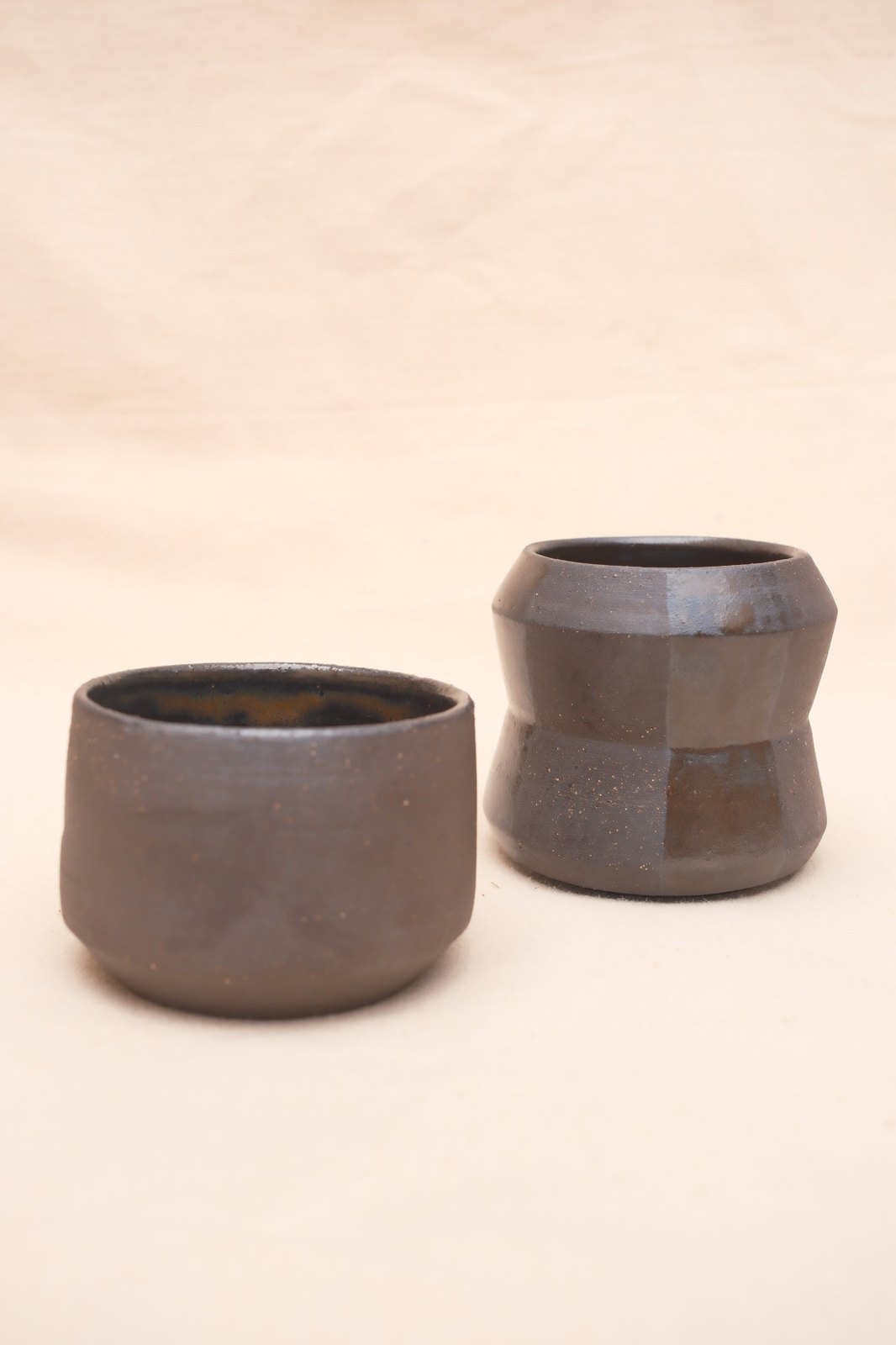 The two cups straight on, showing their different shapes