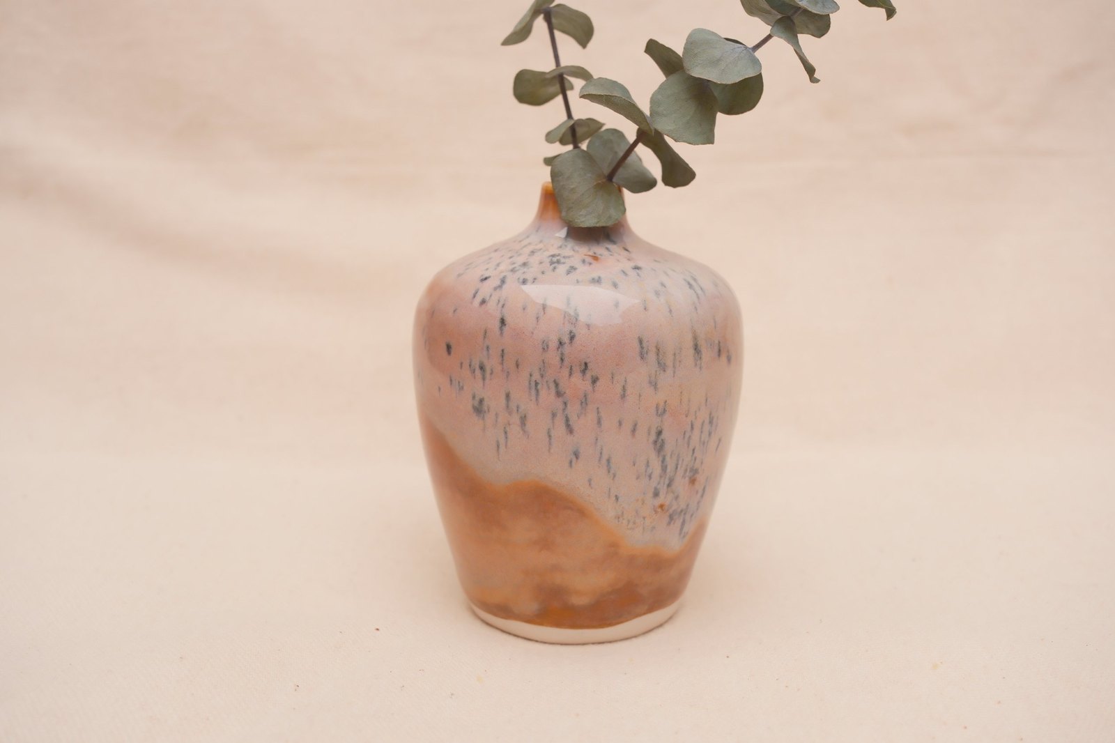 The vase from a raised angle, speckles scattered across the top