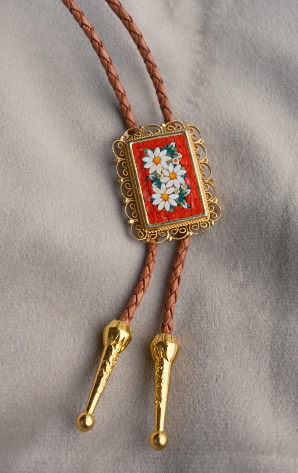Campo Di Fiori bolo tie: Italian micromosaic of white daisies on red, in a gold filigree frame