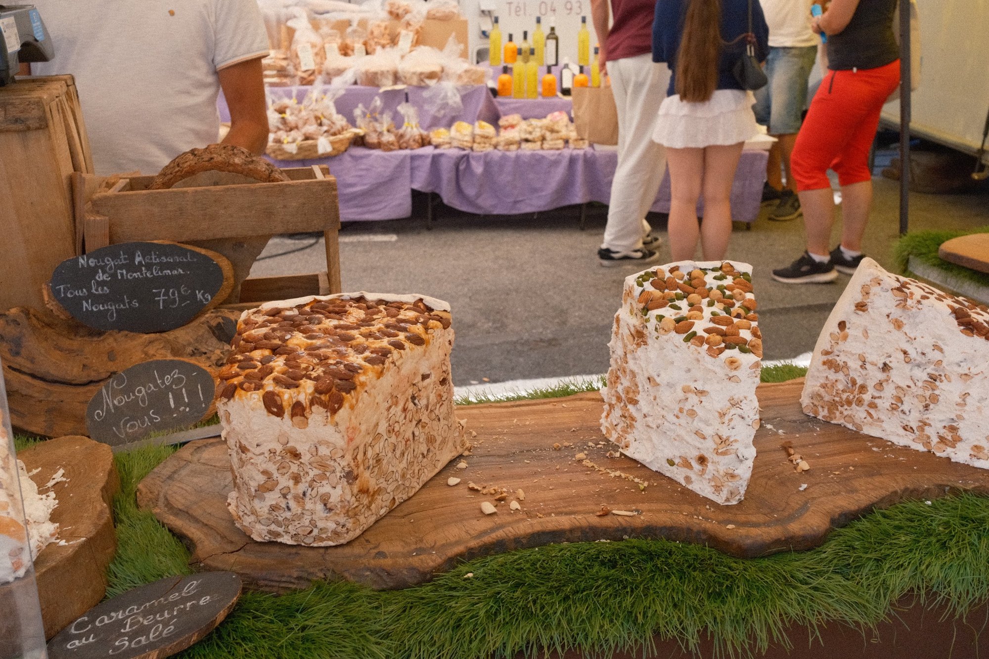 Wheels of almond and pistachio nougat at a Riviera market