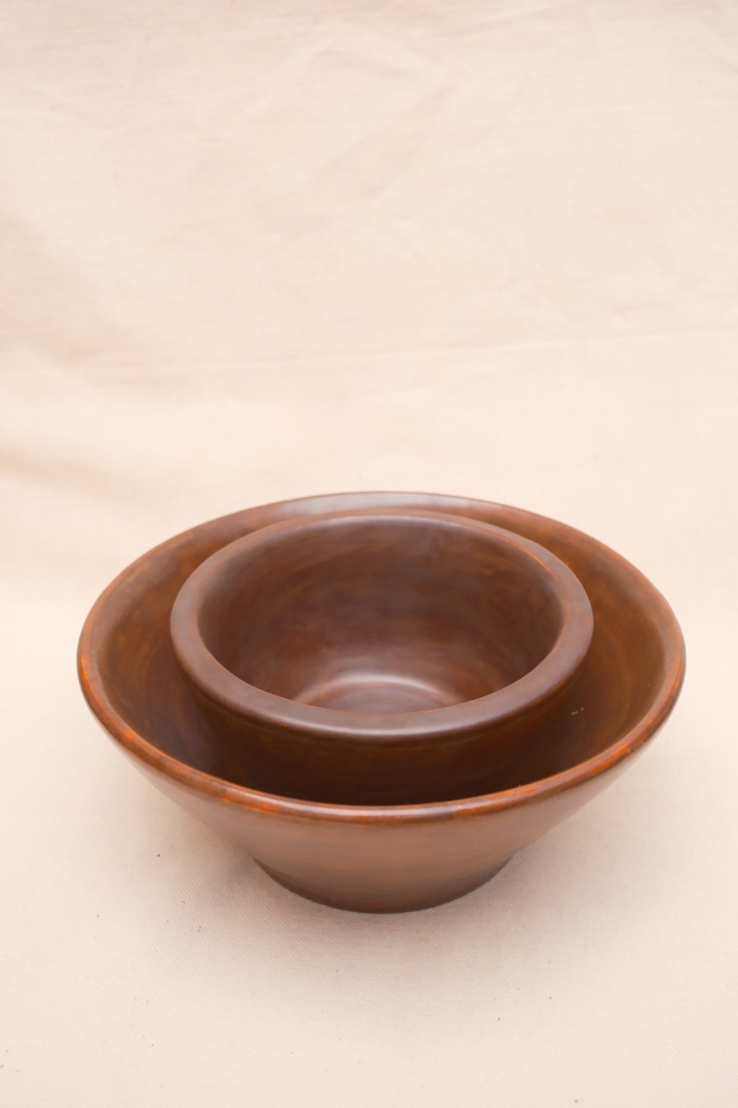 The small bowl nested inside the flared bowl
