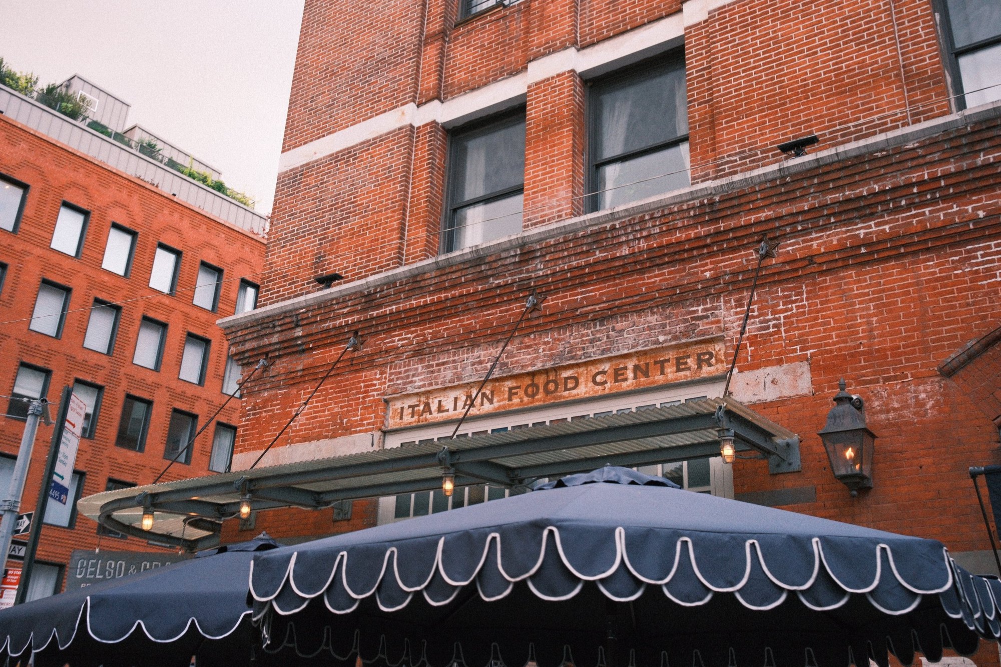 Faded Italian Food Center lettering over a scalloped navy umbrella