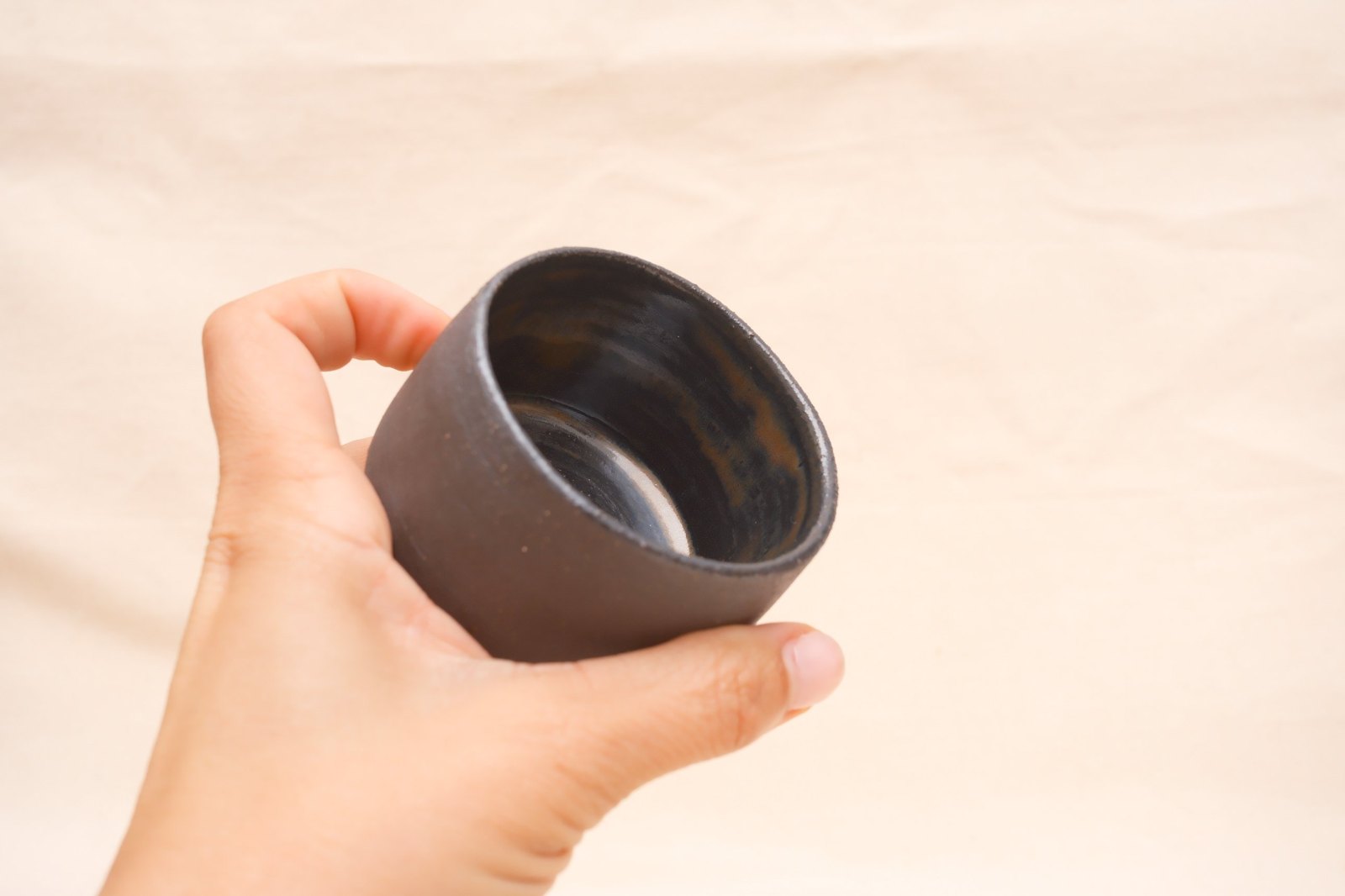 The cup tipped toward the camera in a hand