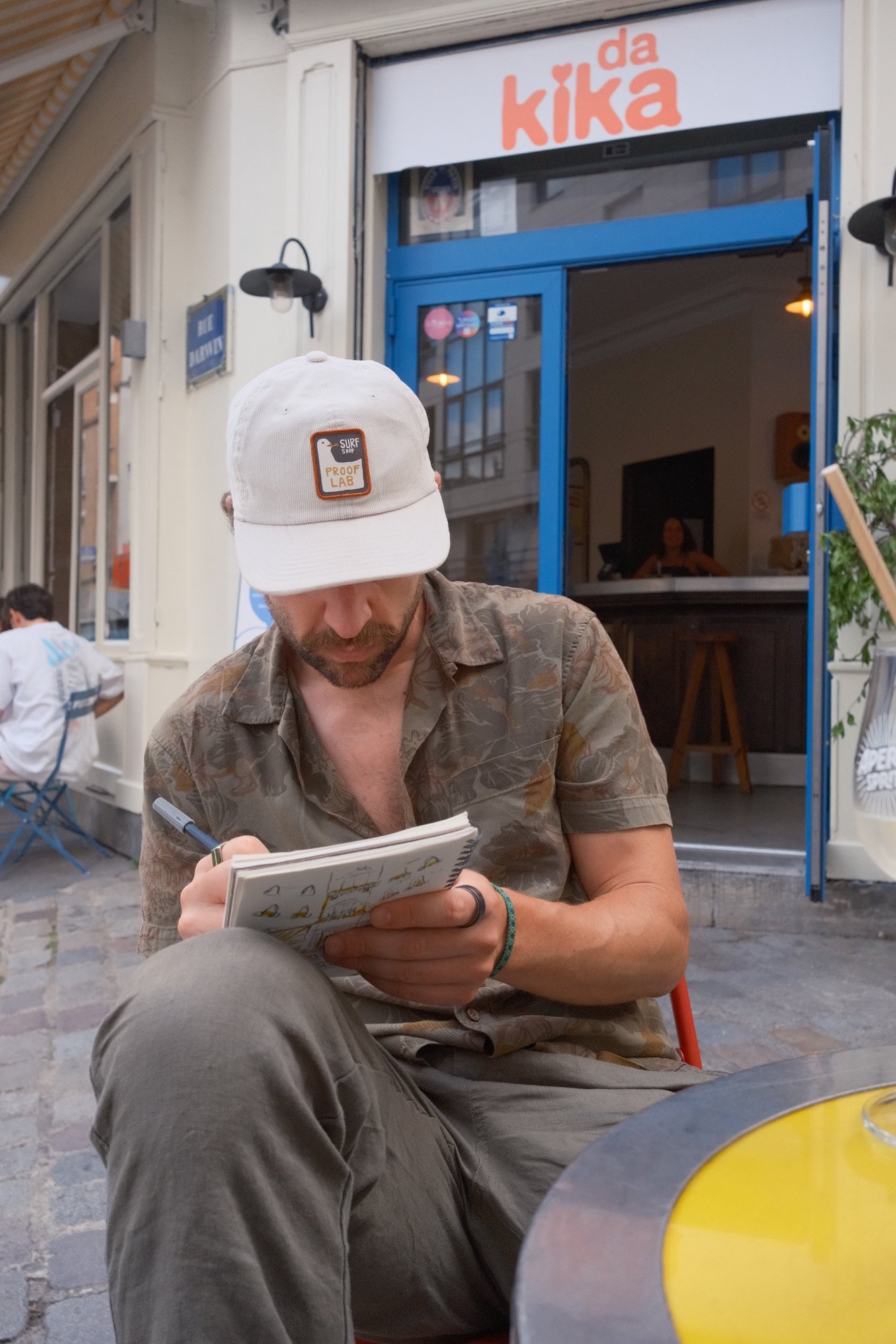 Sketching in a notebook outside da Kika