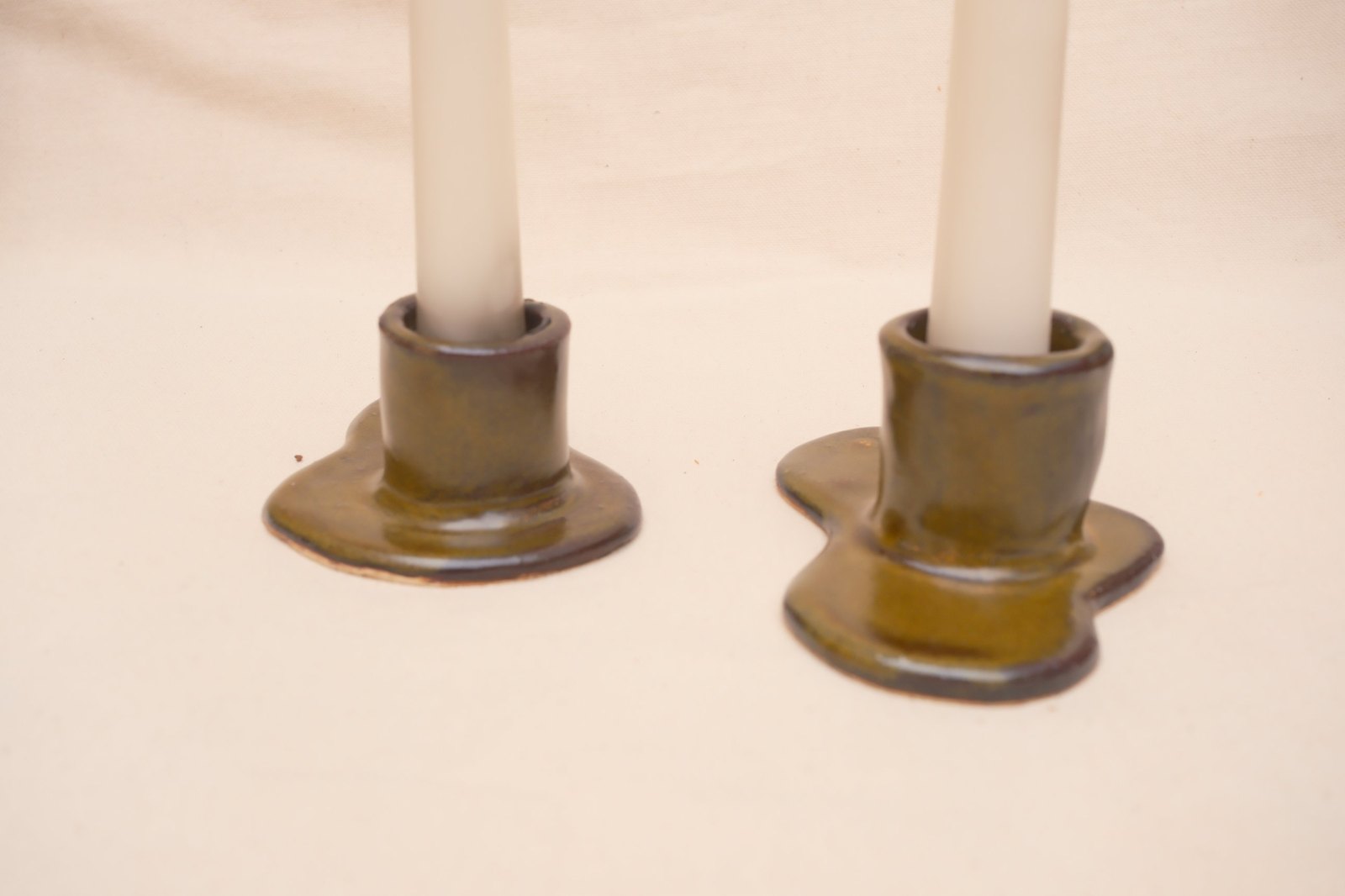 Side view of both holders, raw clay showing at the underside edge