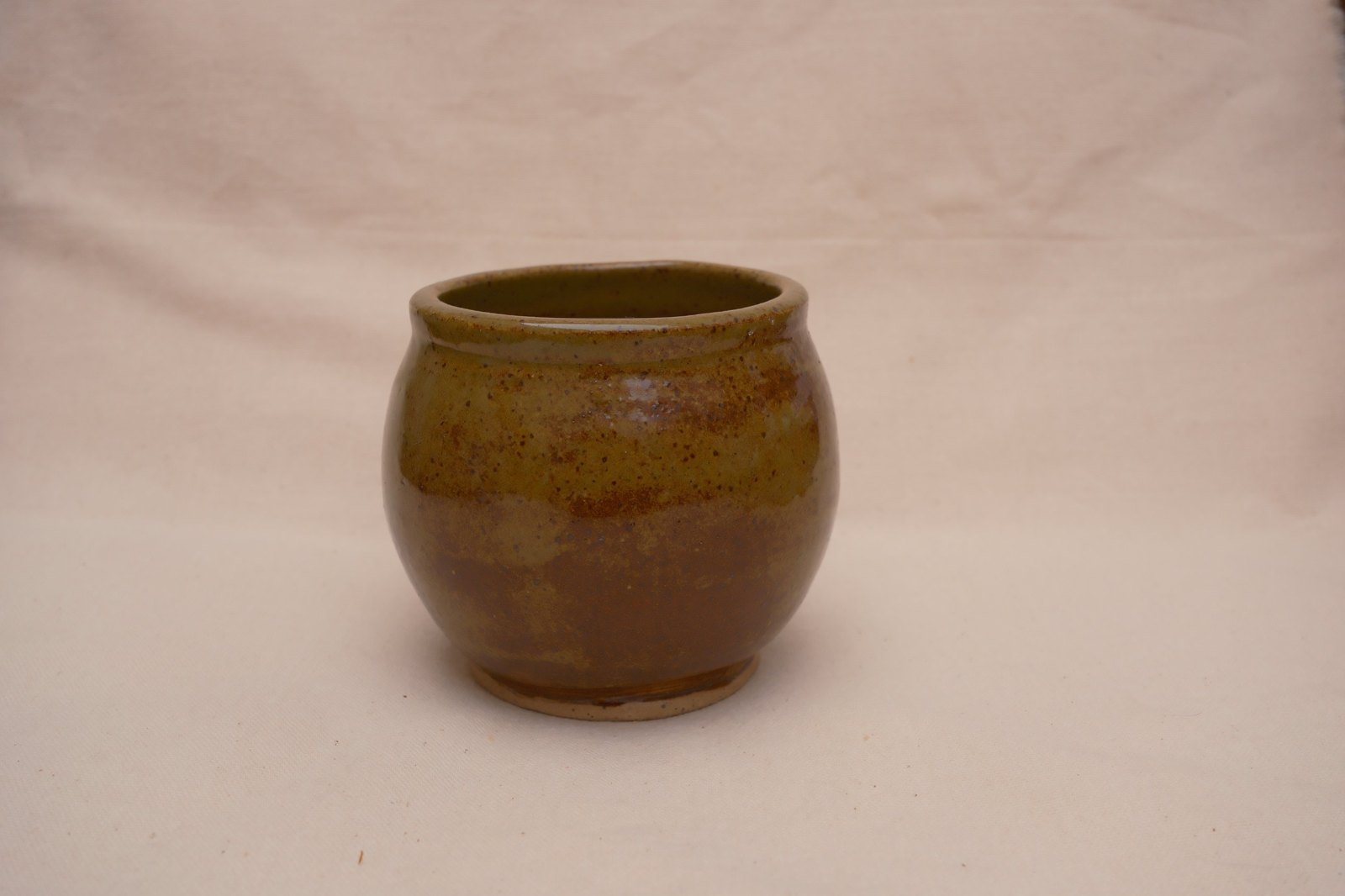The bowl straight on, its rounded belly and bare foot