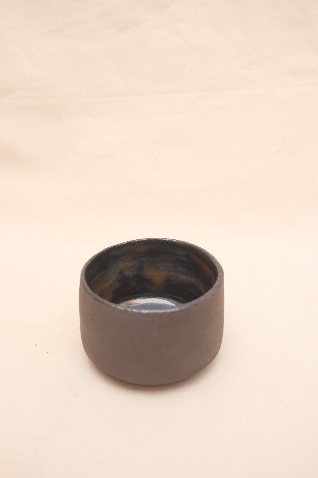 Looking down into the cup at the pooled glossy glaze