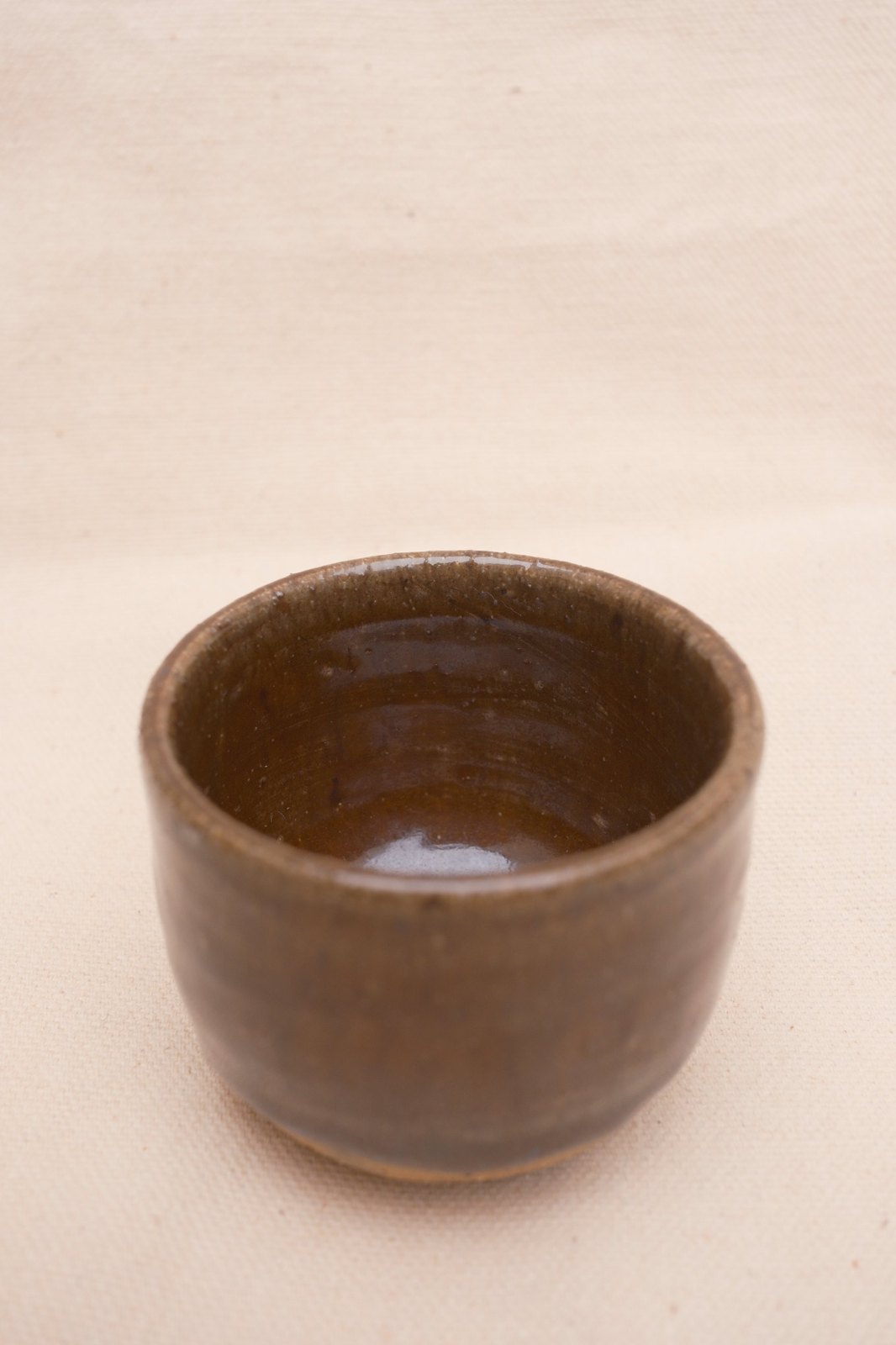 Looking down into the amber cup at the glossy interior and throwing rings