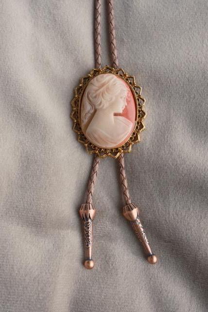 Coral Debutante bolo tie: carved ivory-and-coral cameo in a gold sunburst filigree bezel
